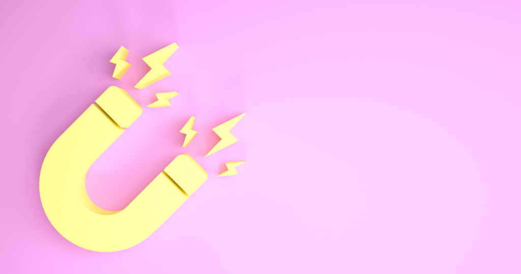 Yellow magnet with lightning bolts sparking from the ends on a pink, lilac background. 