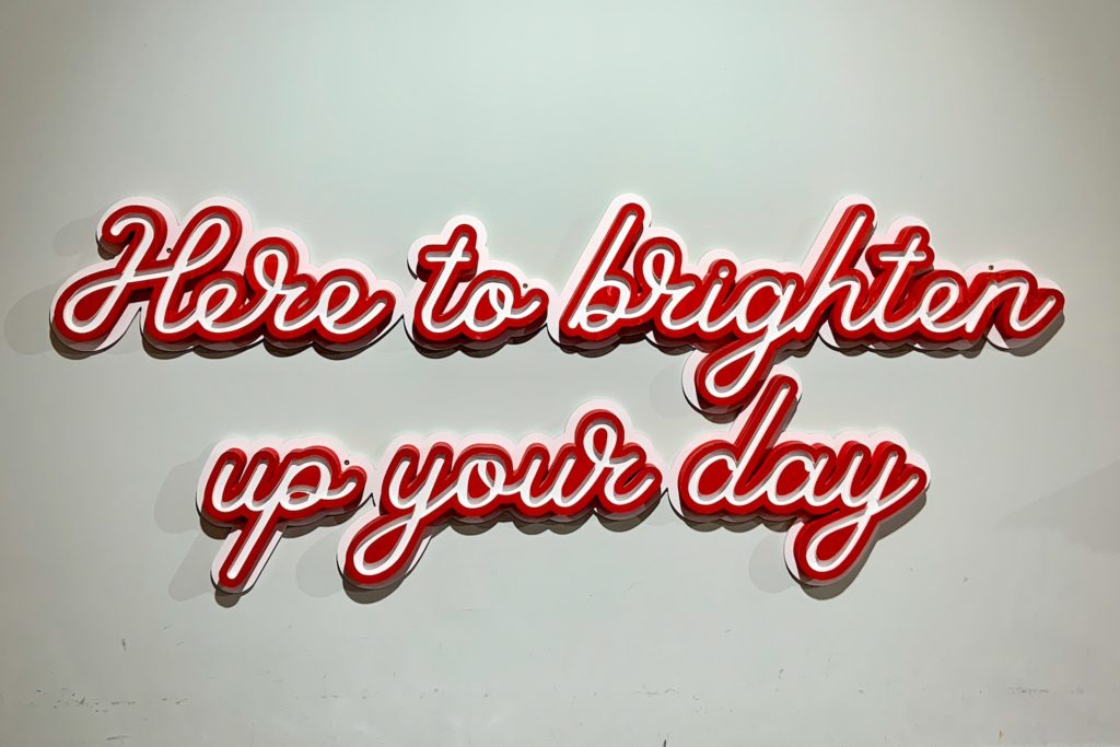 Here to brighten up your day in cursive font